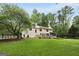 A spacious yard with privacy fence, mature trees, and back deck of home at 100 Hartford Pl, Fayetteville, GA 30214