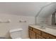 A bathroom with a toilet, vanity and sink, mirror and a large tiled wall at 100 Hartford Pl, Fayetteville, GA 30214