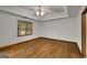 Bright bedroom with hardwood floors, a ceiling fan, and natural light from the window at 100 Hartford Pl, Fayetteville, GA 30214