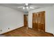 Bedroom with hardwood floors, ceiling fan, closet and a wood-trimmed entry door at 100 Hartford Pl, Fayetteville, GA 30214