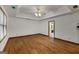 Large bedroom with hardwood floors, tray ceiling, and a view to an attached bathroom at 100 Hartford Pl, Fayetteville, GA 30214