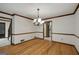 Hardwood dining room with chandelier, white walls, and doorway to kitchen at 100 Hartford Pl, Fayetteville, GA 30214