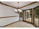 Dining room features wood trim, chandelier, and french doors to outdoor deck at 100 Hartford Pl, Fayetteville, GA 30214