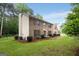 Two-story brick house with manicured lawn, trimmed hedges, and classic exterior architectural elements at 100 Hartford Pl, Fayetteville, GA 30214