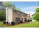 Two-story brick home with well-manicured landscaping, traditional shutters, covered entry, and a lush green lawn at 100 Hartford Pl, Fayetteville, GA 30214