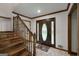 Inviting foyer with beautiful wooden staircase, decorative front door, and tile flooring at 100 Hartford Pl, Fayetteville, GA 30214