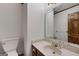 Elegant half bathroom with designer fixtures, a decorative mirror, and a stylish vanity at 100 Hartford Pl, Fayetteville, GA 30214