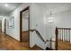 Hallway featuring hardwood floors, decorative chandelier, and access to stairs and living space at 100 Hartford Pl, Fayetteville, GA 30214
