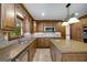 Open kitchen features wood cabinets, granite countertops, and stainless steel appliances at 100 Hartford Pl, Fayetteville, GA 30214