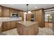 Open kitchen features wood cabinets, granite countertops, and stainless steel appliances at 100 Hartford Pl, Fayetteville, GA 30214