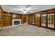 Spacious living room features wood paneling, fireplace, and french doors to outdoor space at 100 Hartford Pl, Fayetteville, GA 30214