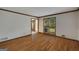 Cozy living room with hardwood floors, large window, and traditional trim detail at 100 Hartford Pl, Fayetteville, GA 30214