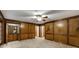 Spacious living room features wood paneling, bar, and multiple entrances to other rooms at 100 Hartford Pl, Fayetteville, GA 30214