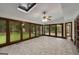 Spacious sunroom featuring a skylight, access to a backyard deck, and large windows at 100 Hartford Pl, Fayetteville, GA 30214