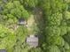 A high aerial view shows a home surrounded by lush green trees at 165 White Rose Ln, Temple, GA 30179