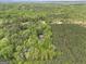 Aerial view of secluded property nestled among dense trees and natural surroundings at 165 White Rose Ln, Temple, GA 30179