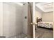 Bathroom with white tiled shower and a view into a bedroom with tray ceiling at 165 White Rose Ln, Temple, GA 30179