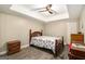 Neutral bedroom boasts tray ceilings, ceiling fan, a wood bed frame, and natural light at 165 White Rose Ln, Temple, GA 30179