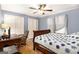 Comfortable bedroom with blue walls, a ceiling fan, and double closets for ample storage at 165 White Rose Ln, Temple, GA 30179