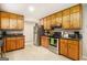 Well-lit kitchen with stainless steel appliances, generous wooden cabinets, and lots of counter space at 165 White Rose Ln, Temple, GA 30179