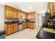 Bright kitchen featuring stainless steel appliances, ample wooden cabinetry, and stylish countertops at 165 White Rose Ln, Temple, GA 30179