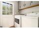 Convenient laundry room with a washer, dryer, and exterior door for easy outdoor access at 165 White Rose Ln, Temple, GA 30179