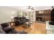 Cozy living room featuring a brick fireplace, hardwood floors, and comfortable leather sofas at 165 White Rose Ln, Temple, GA 30179