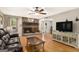 Comfortable living room with a brick fireplace, hardwood floors, and ample natural light at 165 White Rose Ln, Temple, GA 30179