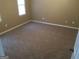 Neutral bedroom with wall-to-wall carpeting and a window providing natural light at 3875 Grand Prix St, Cumming, GA 30041