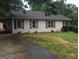 Charming single story home with red shutters and a well manicured front yard at 3875 Grand Prix St, Cumming, GA 30041