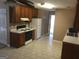 Bright kitchen features white appliances, tile flooring, and wood cabinets at 3875 Grand Prix St, Cumming, GA 30041