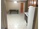 Open kitchen featuring tile flooring, white refrigerator, and view of dining area at 3875 Grand Prix St, Cumming, GA 30041