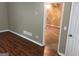Comfortable living area with view into bedroom, temperature control, and hardwood flooring at 3875 Grand Prix St, Cumming, GA 30041