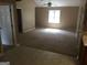 Inviting living room with high ceiling, ceiling fan and carpet, as seen from the kitchen at 3875 Grand Prix St, Cumming, GA 30041