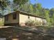 Single story home featuring a low-pitched roof, horizontal siding, and an extended concrete walkway at 30 Woodfield Rd, Covington, GA 30014