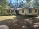 Ranch-style home with charming shutters and ample yard space, awaiting your personal touch at 30 Woodfield Rd, Covington, GA 30014