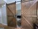Unique interior with large wood barn doors on sliders to a room, with a decorative wreath at 80 Jacksons Vly, Sharpsburg, GA 30277