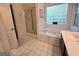 Bathroom featuring a soaking tub with a glass block window and a glass-enclosed shower at 80 Jacksons Vly, Sharpsburg, GA 30277