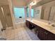 Bright bathroom with a large soaking tub, glass block window, and a dual sink vanity at 80 Jacksons Vly, Sharpsburg, GA 30277