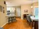 Open-concept dining area with adjacent kitchen and hardwood flooring at 80 Jacksons Vly, Sharpsburg, GA 30277