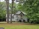 Exterior view of a two-story home with manicured front lawn surrounded by mature trees at 80 Jacksons Vly, Sharpsburg, GA 30277