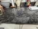 Close-up of kitchen countertop with granite countertops, white cabinets and breakfast nook items at 80 Jacksons Vly, Sharpsburg, GA 30277