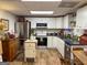 The kitchen features white cabinetry, stainless steel appliances, granite countertops, and wood-look floors at 80 Jacksons Vly, Sharpsburg, GA 30277