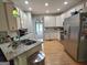 Bright kitchen featuring granite countertops, stainless steel appliances, and hardwood floors at 80 Jacksons Vly, Sharpsburg, GA 30277