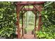 Lush landscape with a wooden pergola, offering a serene outdoor escape at 80 Jacksons Vly, Sharpsburg, GA 30277