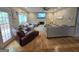 Comfortable living room features a fireplace, ceiling fan, wood floors and sliding door to outdoor deck at 80 Jacksons Vly, Sharpsburg, GA 30277