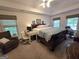 Spacious main bedroom with a large window, work desk, sitting area and tray ceiling at 80 Jacksons Vly, Sharpsburg, GA 30277