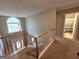 Traditional staircase with carpet runner leading to a bright entryway with a half-moon window at 80 Jacksons Vly, Sharpsburg, GA 30277
