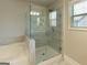 Bright bathroom featuring a walk-in shower with glass enclosure and a soaking tub at 360 Hayden Cir, Woodstock, GA 30189