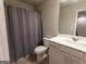 Neutral bathroom featuring a shower with grey shower curtain, toilet, and white vanity with sink at 360 Hayden Cir, Woodstock, GA 30189